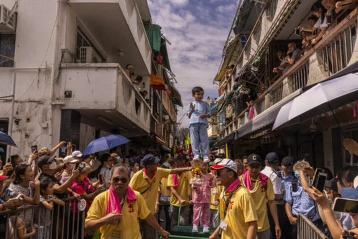 AP PHOTOS: Hong Kong's colorful Bun Festival returns after COVID-19 cancellations
