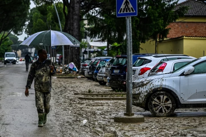 Bereft but alive: dazed residents clean-up after Italy floods